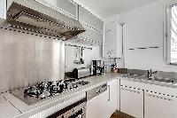 large kitchen with kitchen counter, washer and dryer combo in a 1-bedroom Paris luxury apartment