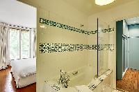 en-suite bathroom with a bathtub and a handheld shower head in a 1-bedroom Paris luxury apartment