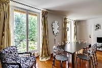 large living room features two full-length, double-glazed French windows with a bright, airy and qui