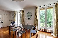large living room features two full-length, double-glazed French windows with a bright, airy and qui