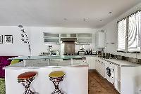 large kitchen with kitchen counter, washer and dryer combo in a 1-bedroom Paris luxury apartment