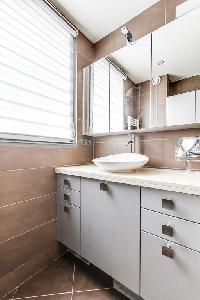 lovely bathroom with a sink and walk-in shower  in a 1-bedroom Paris luxury apartment