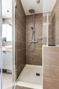 lovely bathroom with a sink and walk-in shower  in a 1-bedroom Paris luxury apartment