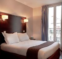 very neat double bed, fine finishes, and draped window in Hotel Verlain in Paris