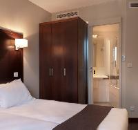 very neat double bed, fine finishes, and sleek bathroom in Hotel Verlain in Paris