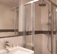 sleek shower area in a modern 3-star Paris Property for sale near Louvre Museum