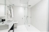 sleek white shower area in Hotel Waldorf Madeleine in Paris