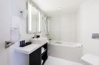 sleek white bathroom in Hotel Waldorf Madeleine in Paris