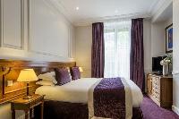 modern room with handful of tastefully made wooden furniture in Hotel Waldorf Madeleine in Paris