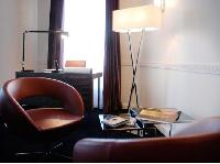 modern room with handful of tastefully made wooden furniture in Hotel Waldorf Madeleine in Paris