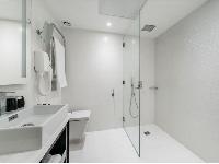 sleek white shower area in Hotel Waldorf Madeleine in Paris