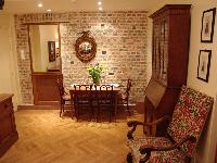 dining area with exposed brick wall, perfectly lined parquet floors, the solid oak or walnut furnitu