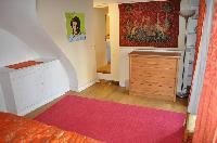 bright bedroom in tangerine hue in a 2-bedroom Paris luxury apartment