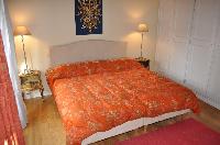 warm and bright master bedroom with two twin beds or a king size bed in a 2-bedroom Triplex Paris ap