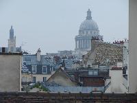 second bedroom with rooftop terrace overlooking the Paris skyline and its picturesque rooftops and t