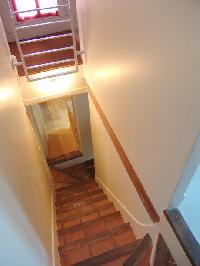 internal staircase connecting three floors in a 2-bedroom Triplex Paris apartment