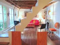 internal staircase connecting three floors in a 2-bedroom Triplex Paris apartment