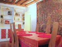 dining area for 6 with styish carpet, exposed beams and shelves in a 2-bedroom Triplex Paris apartme