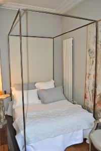 comfy bed with 4 pillars in Paris luxury apartment