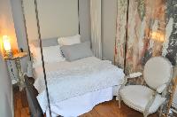 neatly stocked bedroom with a queen size bed in Paris luxury apartment