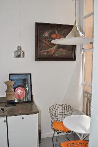 round coffee table for 2 beneath a ceiling lamp overlooking the courtyard in Paris luxury apartment