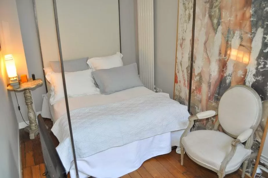 neatly stocked bedroom with a queen size bed in Paris luxury apartment