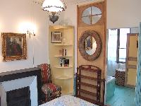 charming 1 bedroom Paris luxury apartment with interior oak shutter, oeil de boeuf oval windows, and