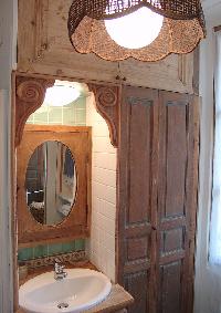 wooden door, countertop, and framed mirror in Paris luxury apartment
