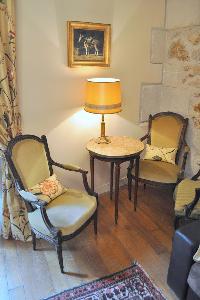 cream armchairs with nightstand and lamp in Paris luxury apartment