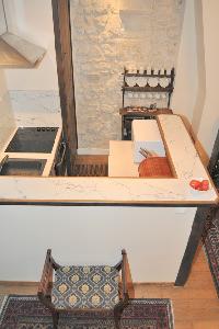 well-equipped kitchen with counter and stool in Paris luxury apartment