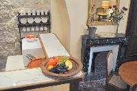 well-equipped kitchen with counter and stool in Paris luxury apartment