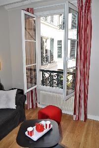 two large windows that open onto the quiet courtyard in Paris luxury apartment