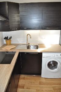 well-equipped kitchen with washer in Paris luxury apartment