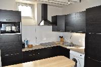 well-equipped kitchen with washer in Paris luxury apartment