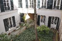 overlooking the quiet courtyard from the windows of Paris luxury apartment