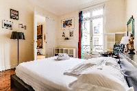 second bedroom features a king-sized style bed and ensuite in a 4-bedroom Paris luxury apartment