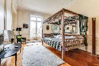 third bedroom with a queen-sized bed in a 4-bedroom Paris luxury apartment