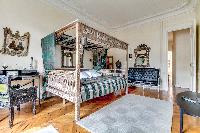 third bedroom with a queen-sized bed in a 4-bedroom Paris luxury apartment