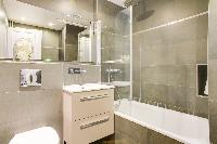 clean and fresh bathroom with tub in République - Voltaire luxury apartment