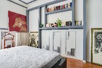 master bedroom with a queen size bed in a 2-bedroom Paris luxury apartment