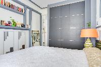master bedroom with a queen size bed in a 2-bedroom Paris luxury apartment