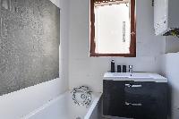 well-kept and modern bathroom and kitchen sink in a 2-bedroom Paris luxury apartment