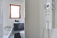 well-kept and modern bathroom and kitchen sink in a 2-bedroom Paris luxury apartment