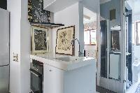 well-kept and modern bathroom and kitchen sink in a 2-bedroom Paris luxury apartment