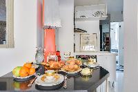 well-ventilated dining area and well-equipped kitchen in a 2-bedroom Paris luxury apartment