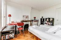 second bedroom with two single beds, study desk, shelves, and ornamental fireplace in a 3-bedroom Pa