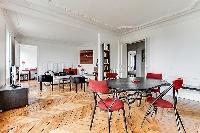 spacious dining area with 4 seats in a 3-bedroom Paris luxury apartment