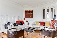 sitting area with comfortable sofas and armchairs in a 3-bedroom Paris luxury apartment