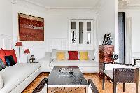 sitting area with comfortable sofas and armchairs in a 3-bedroom Paris luxury apartment