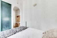 contemporary bedroom and a full bathroom in a charming studio Paris apartment